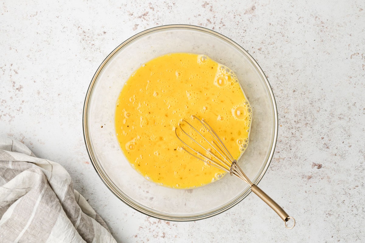 Whisked Eggs in a clear glass bowl.