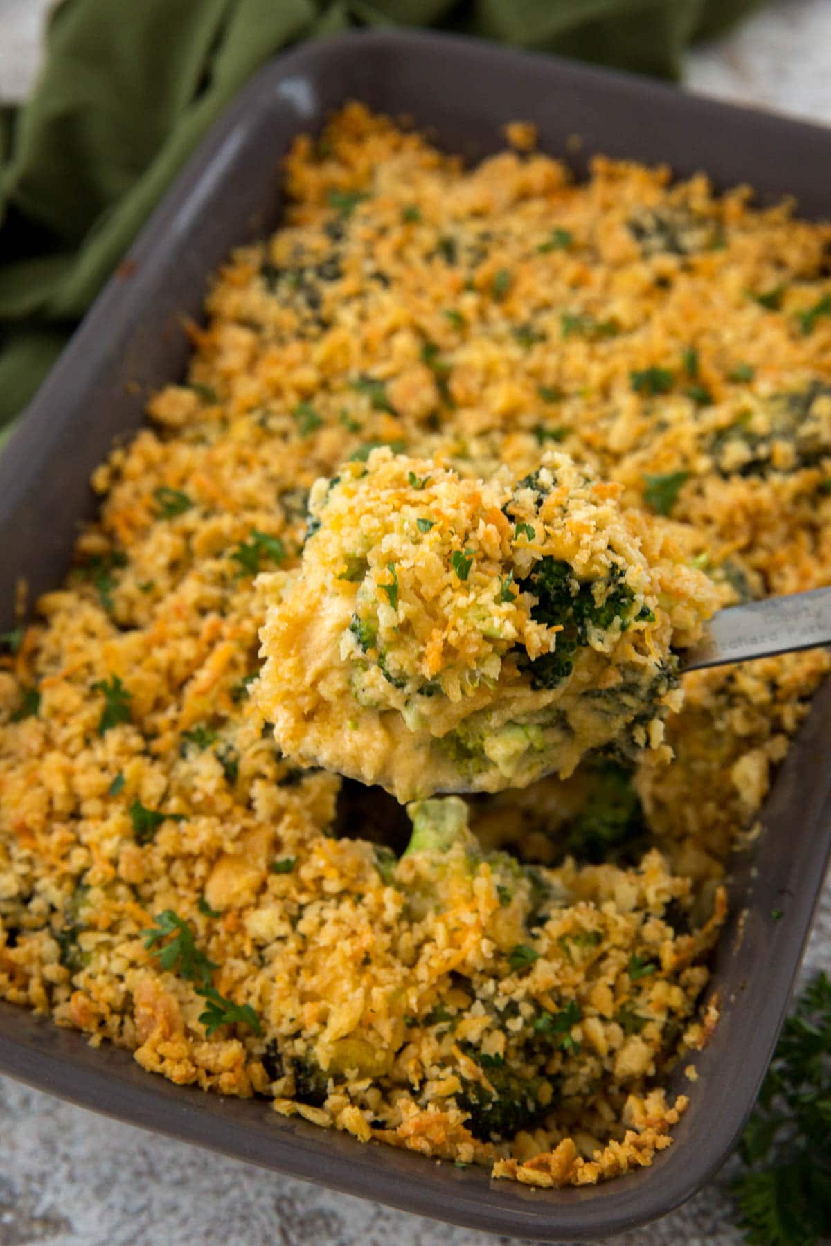gray baking dish, broccoli casserole, serving spoon