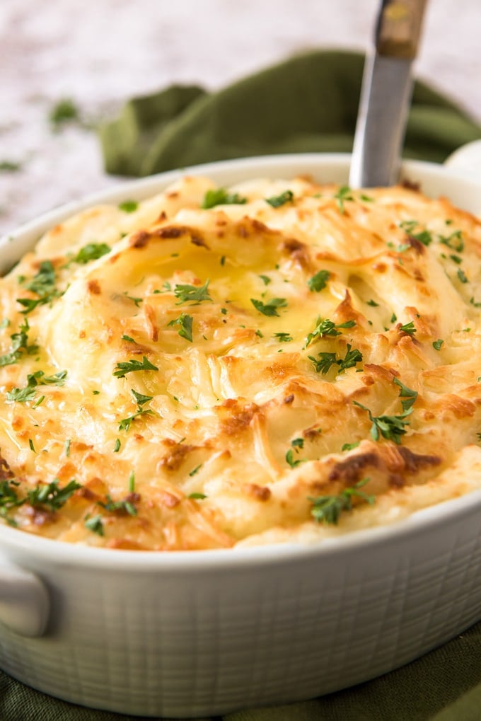 a side view of a dish of baked mashed potatoes with cheese
