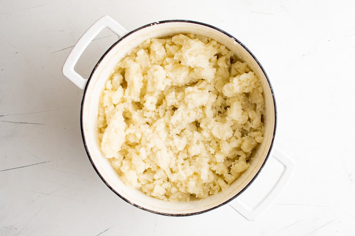 Potatoes, mashed, in a large pot.