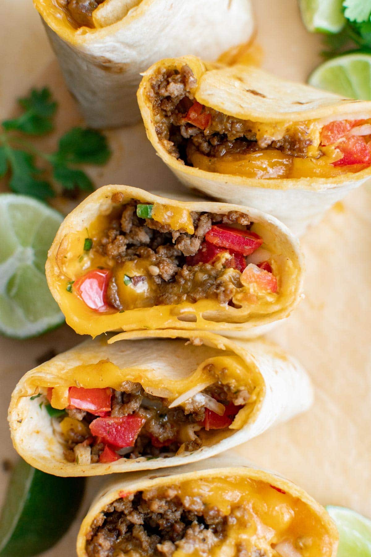 Meximelts standing up showing the meat, cheese and pico de gallo inside