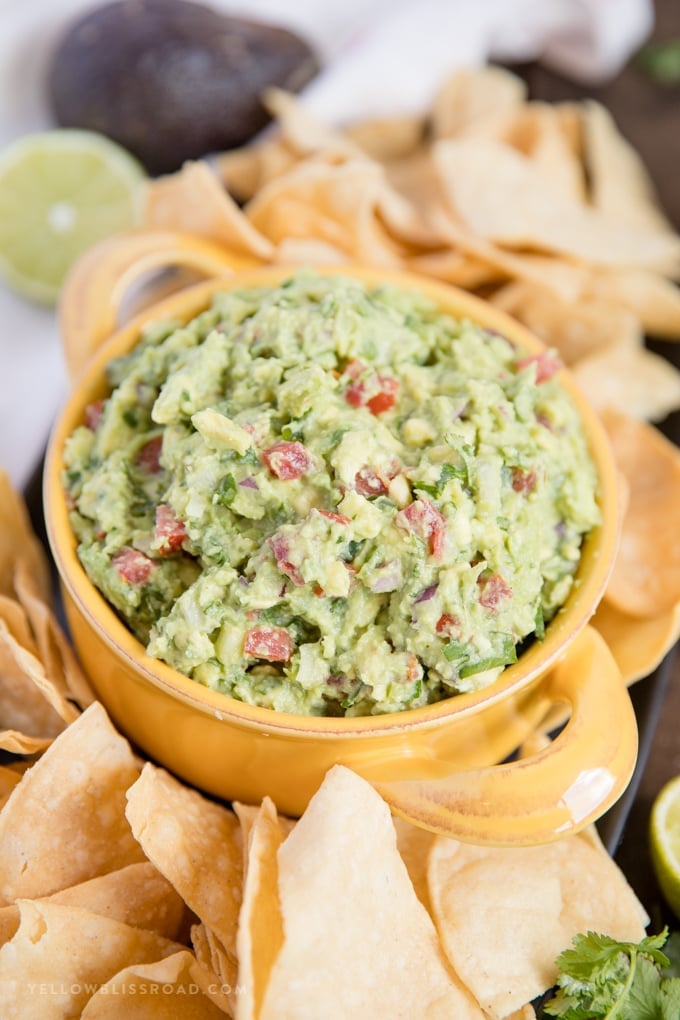 a yellow bowl filled with the best guacamole