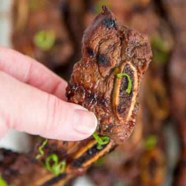 Hand holding up Korean short ribs