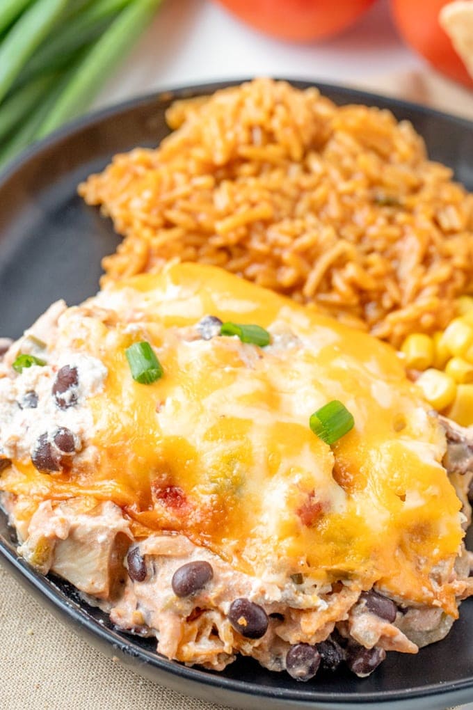 A plate filled with Mexican Chicken Casserole, rice, and corn.