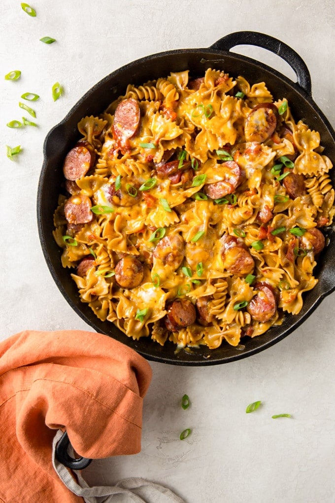 One Pan Cheesy Sausage Pasta recipe has smoked sausage and pasta in a spicy, creamy sauce cooked in one pan for a quick weeknight meal.