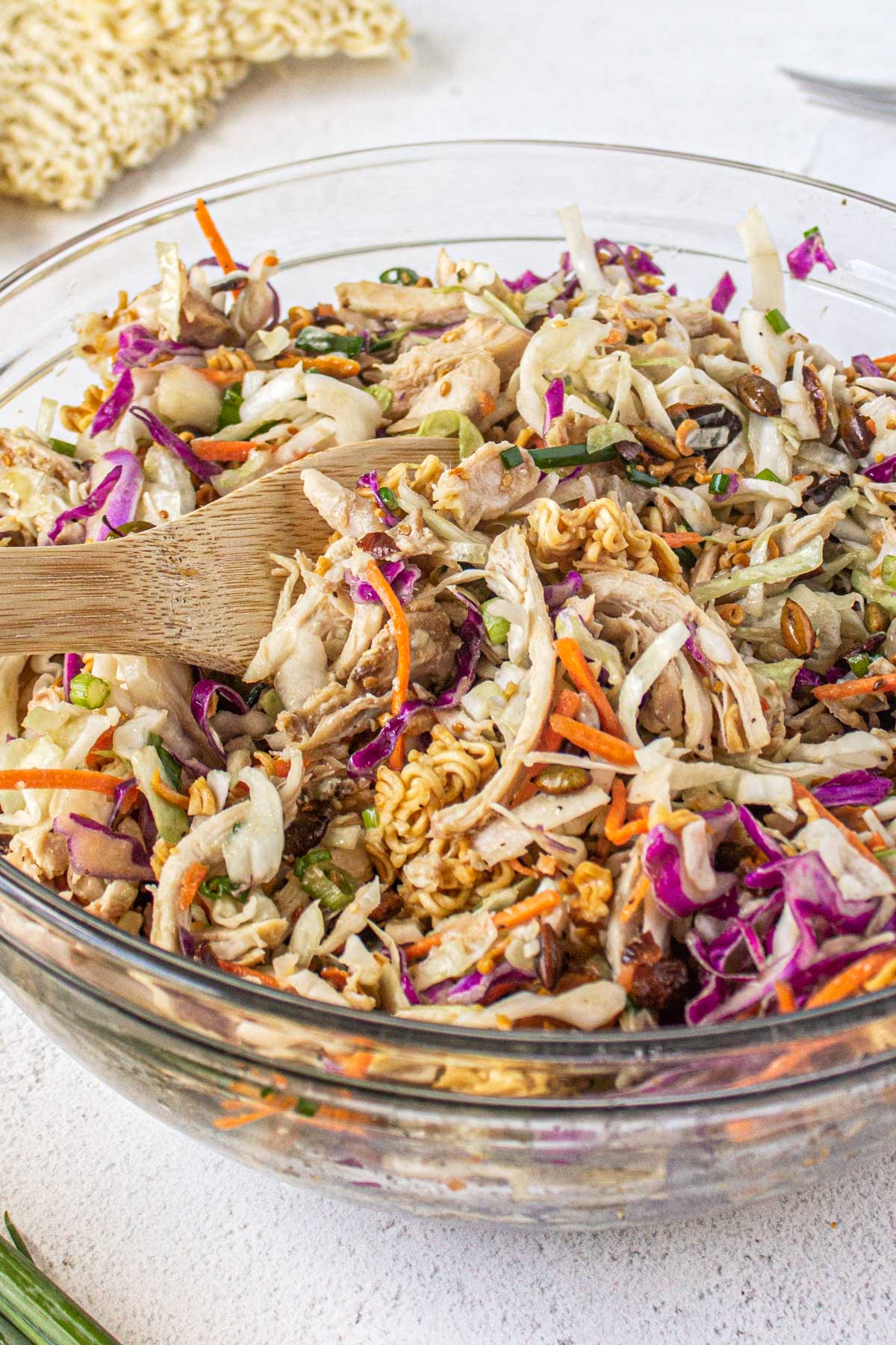 ramen noodle salad in a bowl, a wooden spoon