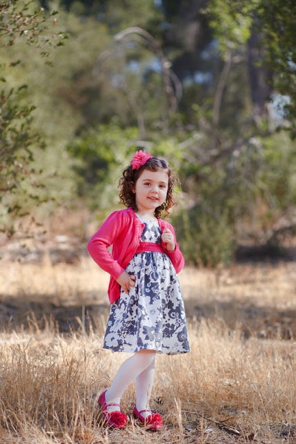 A little girl standing in a field