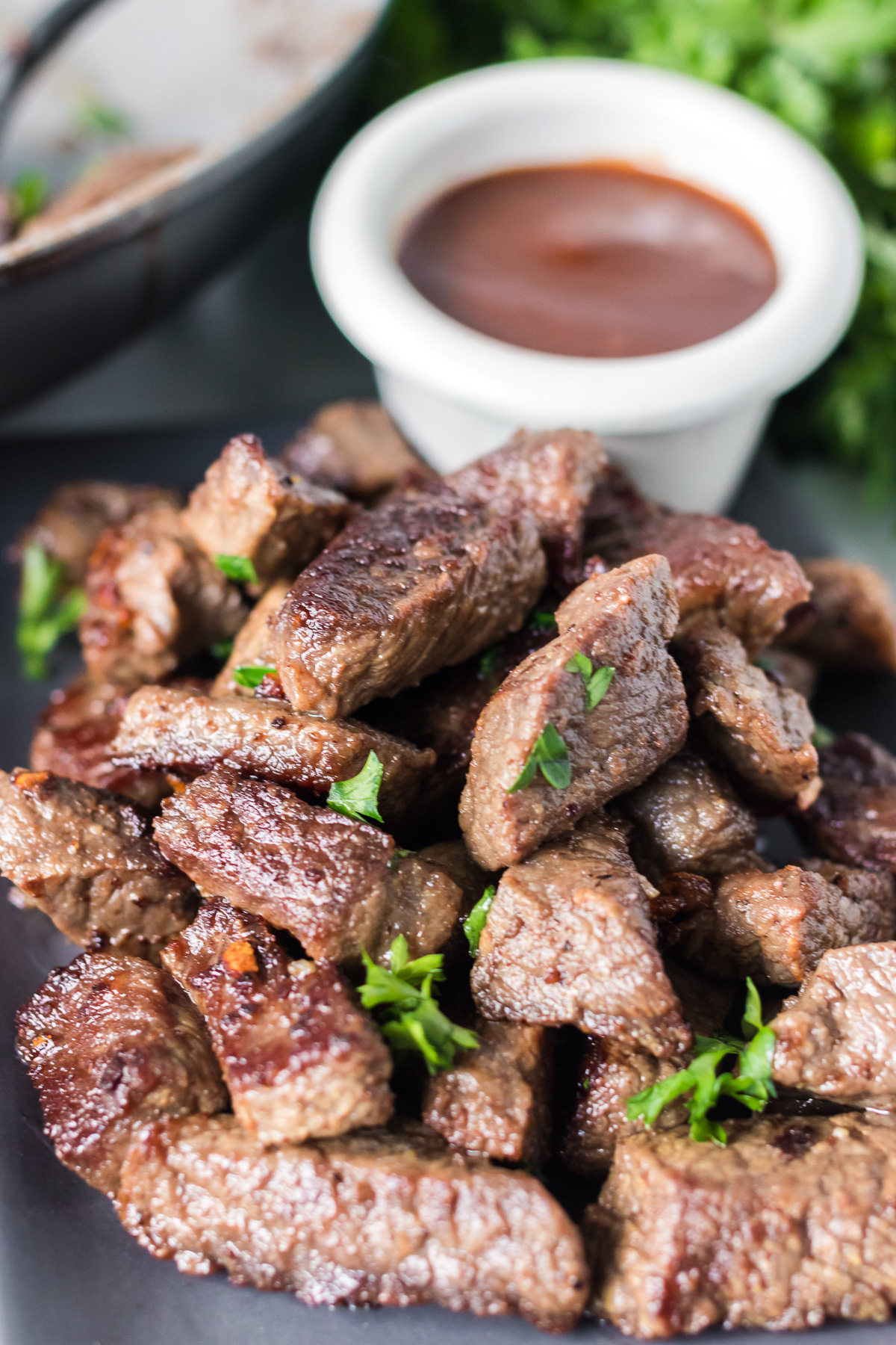 plate of steak bites topped with parsley