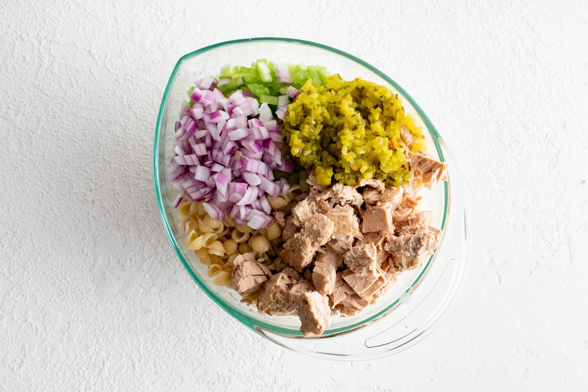 Tuna, relish, onions and celery in a glass dish.