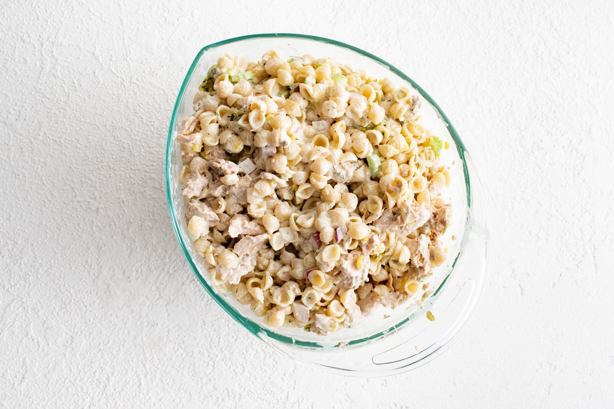 Creamy pasta salad in a glass dish.